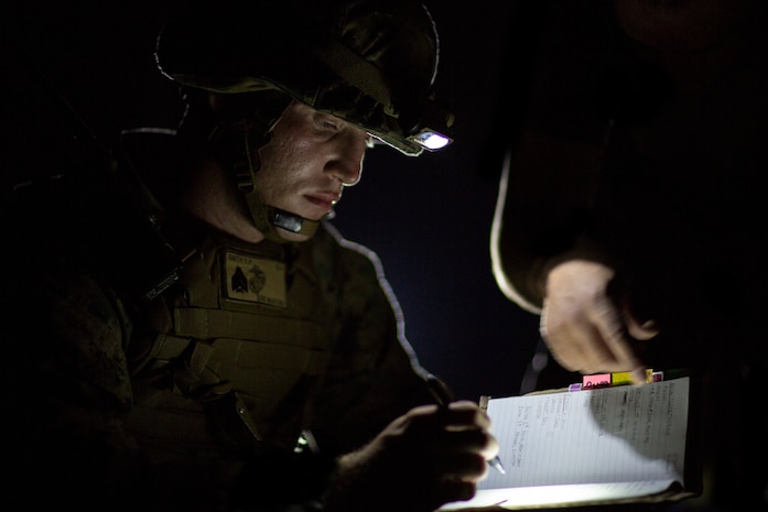 A U.S. Marine receives information on a simulated chemical hazard during Explosive Ordinance Disposal Exercise 19 on Camp Hansen, Okinawa, Japan, Sept. 17.