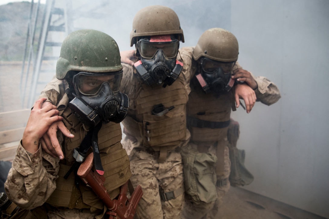 Students with Field Medical Training Battalion - West assist a simulated casualty during the Field Medical Service Technician Course final exercise on Marine Corps Base Camp Pendleton, Calif., Sept. 19.