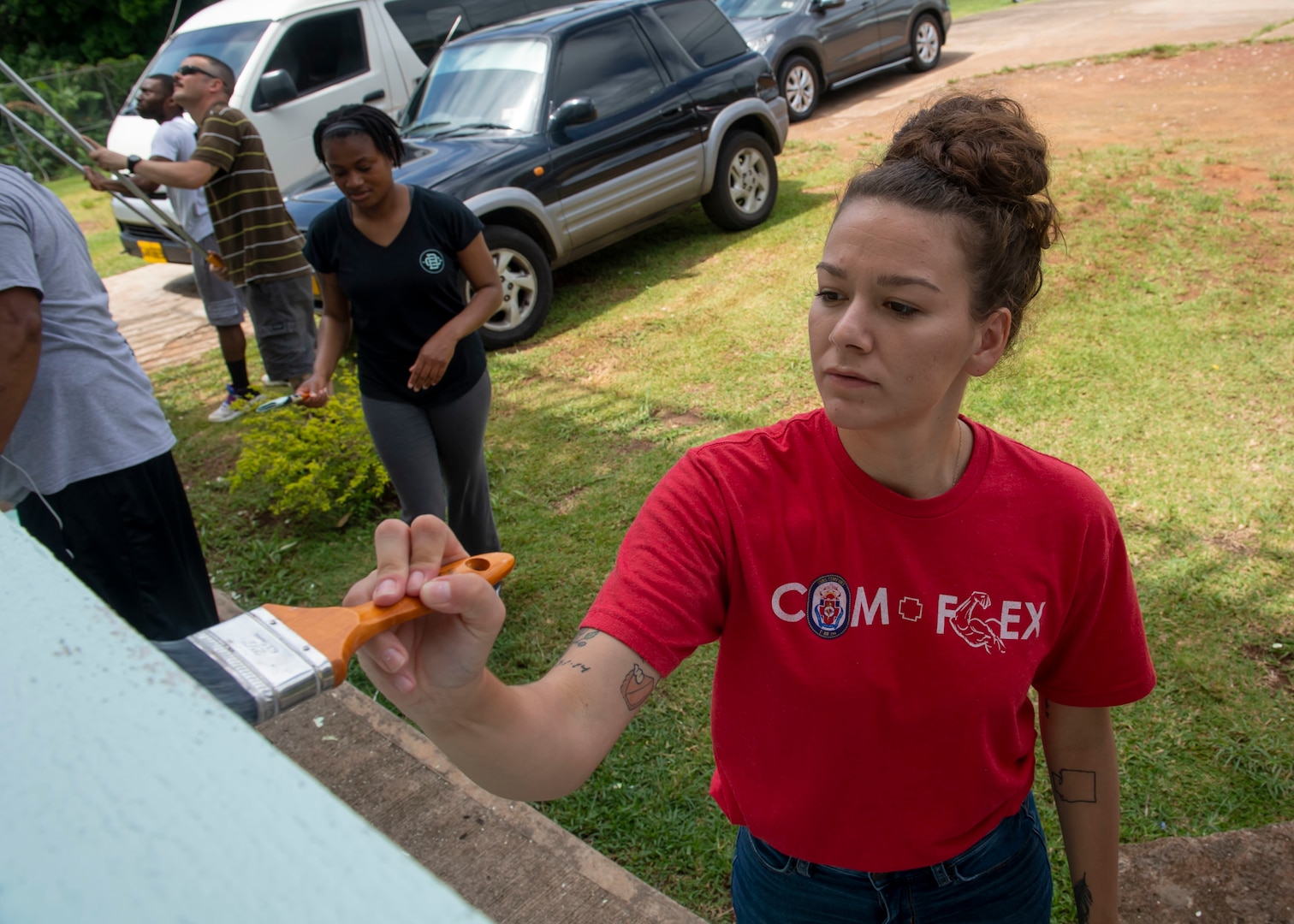 A woman paints a juvenile detention center in St. George's, Grenada.