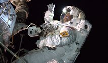 U.S. Army and NASA astronaut Andrew Morgan waves as he is photographed during a Aug. 21, 2019 Extra Vehicular Activity (EVA), also known as a space walk, to install the International Space Station’s second commercial crew vehicle docking port, the International Docking Adapter-3. (Photo Courtesy NASA/Astronaut Nick Hague)