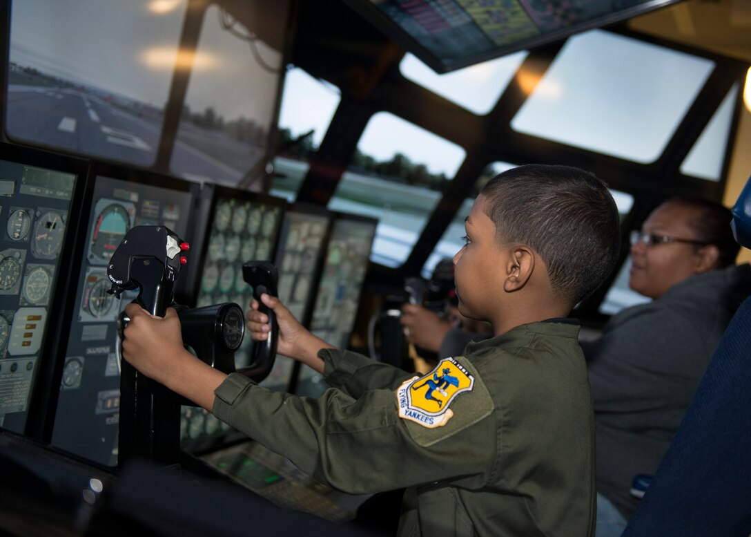 Jadiel Aponte, 103rd Airlift Wing honorary Pilot for a Day, and his mother, Lisa Matta, fly the wing’s multi-mission crew trainer during the unit’s annual Pilot for a Day event at Bradley Air National Guard Base, East Granby, Conn. Sept. 19, 2019. The program puts the wing in partnership with local hospitals to identify a child with a life-threatening or terminal illness and bring them on base to meet members of the wing and learn about its mission. (U.S. Air National Guard photo by Staff Sgt. Steven Tucker)