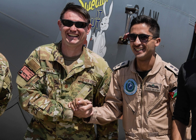 Maj. Sam Smith, a C-130H3 navigator from the 700th Airlift Squadron, poses with a member of the Royal Jordanian Air Force after a successful flight in Jordan during Exercise Eager Lion on Sept. 2, 2019.