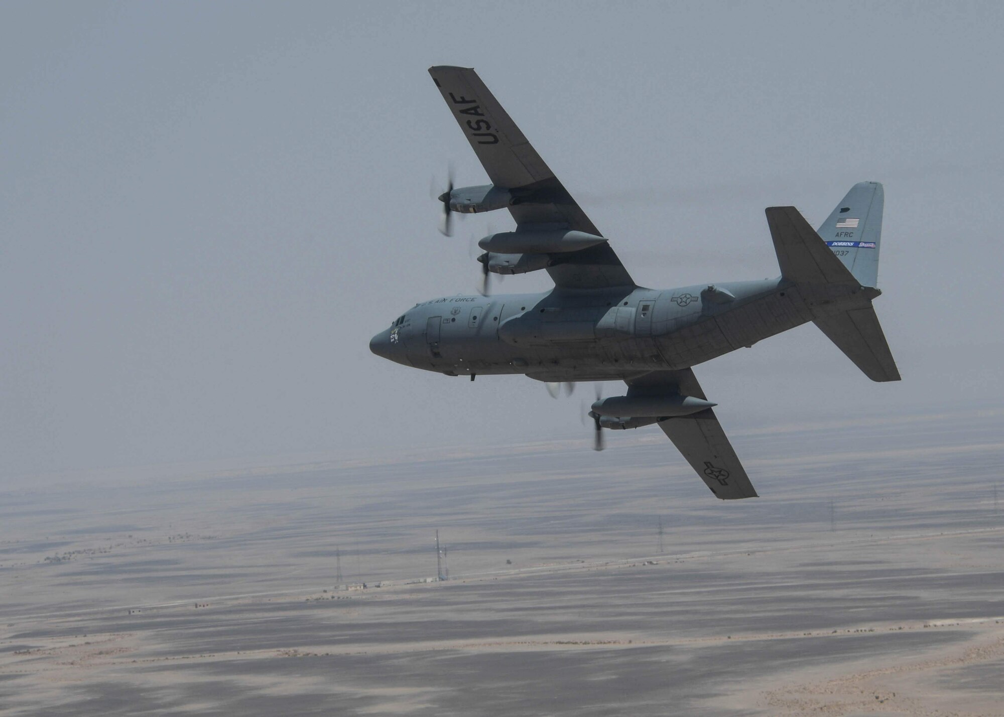 A C-130H3 from Dobbins Air Reserve Base, Ga., banks right as part of a controlled turn in a flight formation during Exercise Eager Lion on Sept. 1, 2019 in Jordan.