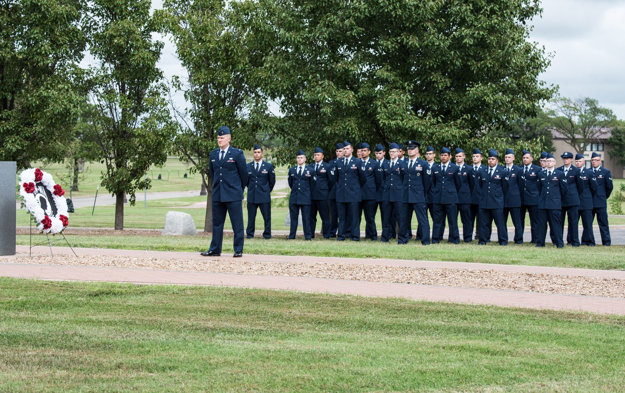 Members of Team McConnell stand in formation during the 2019 prisoner(s) of war/missing in action Retreat Ceremony Sept. 20, 2019, at McConnell Air Force Base, Kan. The ceremony signified the end of the POW/MIA Remembrance Week that was held in honor of POW's and those who are still missing in action. (U.S. Air Force photo by Senior Airman Alan Ricker)