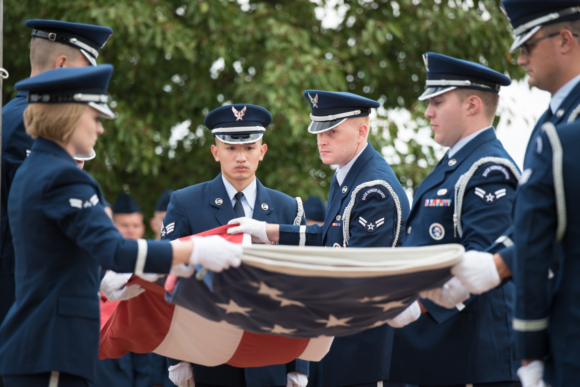 McConnell's Honor Guard flag detail folds the American flag during the 2019 prisoner(s) of war/missing in action Retreat Ceremony Sept. 20, 2019, at McConnell Air Force Base, Kan. The installation honored those that served to protect and preserve the rights, privileges and freedoms by sacrificing their lives in service to their country. (U.S. Air Force photo by Senior Airman Alan Ricker)