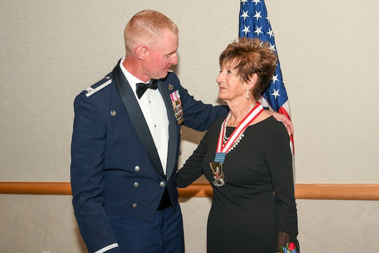 Karen Hill, a restauranter from Ogden, receives the Hill Air Force Base Community Wingman Award from Col. Jon Eberlan, 75th Air Base Wing commander, at Hill's Air Force Ball Sept. 21, 2019. The annual honor recognizes a community member who has made a significant service contribution to the installation.