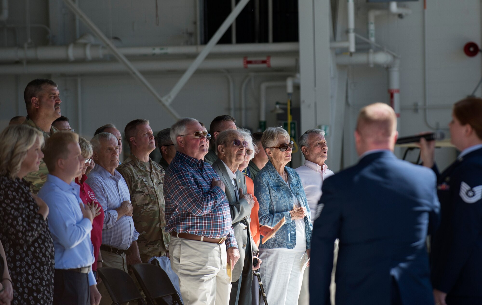 Service members from the Minnesota National Guard, along with family and friends of U.S. Air Force Col. Daniel Gabrielli, stand during the national anthem in St. Paul, Minn., Sept. 14, 2019.
