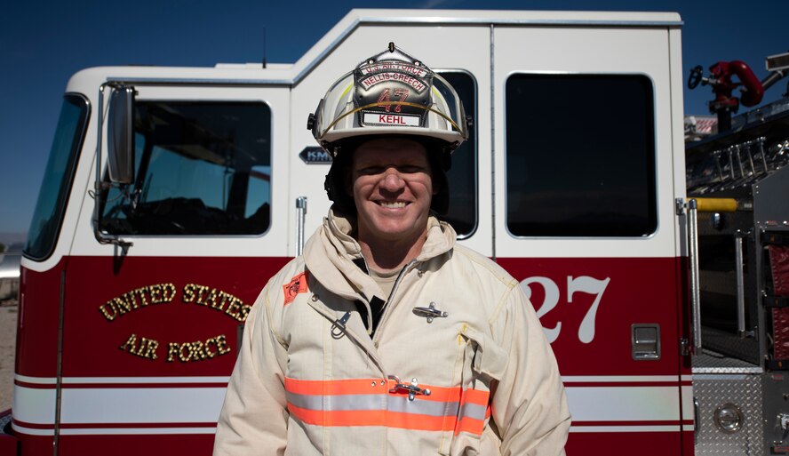 Senior Master Sgt. Andrew Kehl, 99th Civil Engineer Squadron Fire Department deputy fire chief, poses for a photo in front of a fire truck at Nellis Air Force Base, Nevada, July 29, 2019. Kehl was recently honored as one of the Air Force’s 12 Outstanding Airmen of the Year for 2019. (U.S. Air Force photo by Airman 1st Class Bailee A. Darbasie)