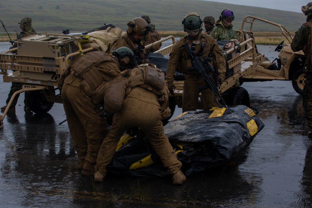 U.S. Marines with Marine Wing Support Squadron 371 unfold a fuel berm at a forward arming and refueling point (FARP) during Arctic Expeditionary Capabilities Exercise (AECE) in Adak, Alaska on Sept. 18, 2019. Approximately 3,000 U.S. Navy and Marine Corps personnel are participating in AECE 2019, a joint training exercise that tests expeditionary logistical capabilities in the Arctic region and prepares joint forces to respond to crises across the Indo-Pacific. (U.S. Marine Corps photo by Lance Cpl. Tia D. Carr)