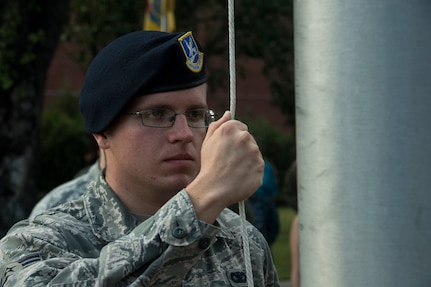 Airman 1st Class Alexander Elkins, 628th Security Forces Squadron installation entry controller, prepares to lower the U.S. Flag during a retreat ceremony Sep. 20, 2019, at Joint Base Charleston, S.C.