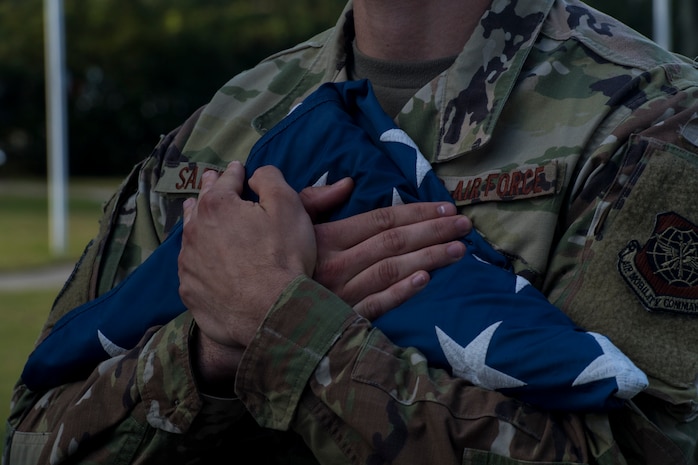 Senior Airman Jack Safford, 628th Logistics Readiness Squadron vehicle maintenance technician, holds a folded flag after a retreat ceremony Sep. 20, 2019, at Joint Base Charleston, S.C.