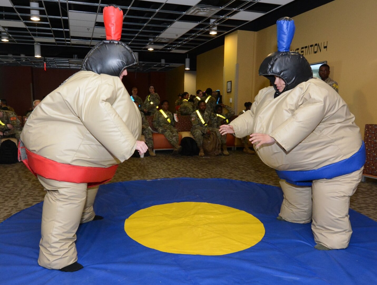 Two Soldiers have fun in Sumo wrestler costumes.
