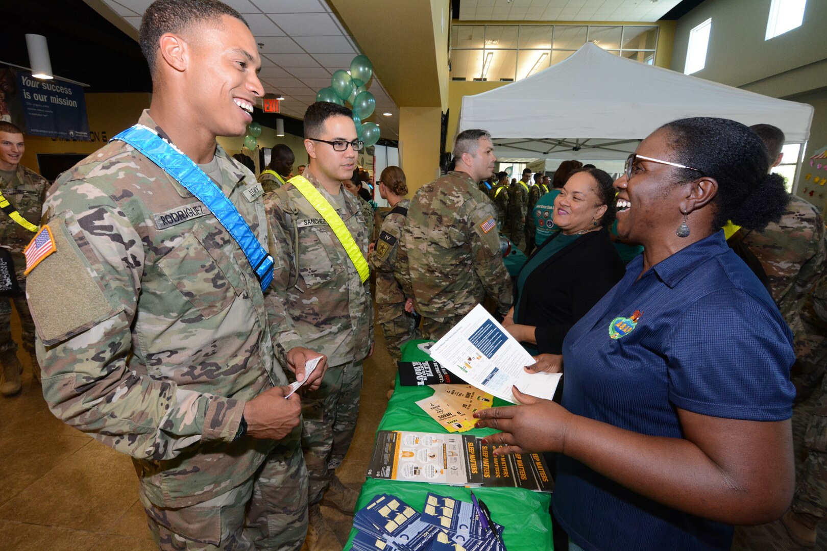 Volunteers from the Army Substance Abuse Program, or ASAP, hand out literature to Soldiers.
