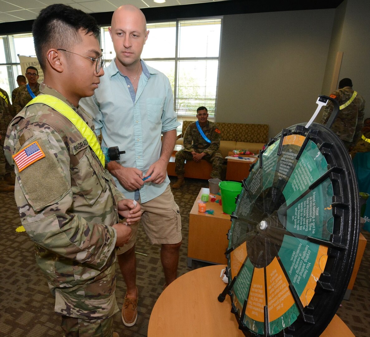 A Soldier spins the SHARP wheel that contains questions about the program.
