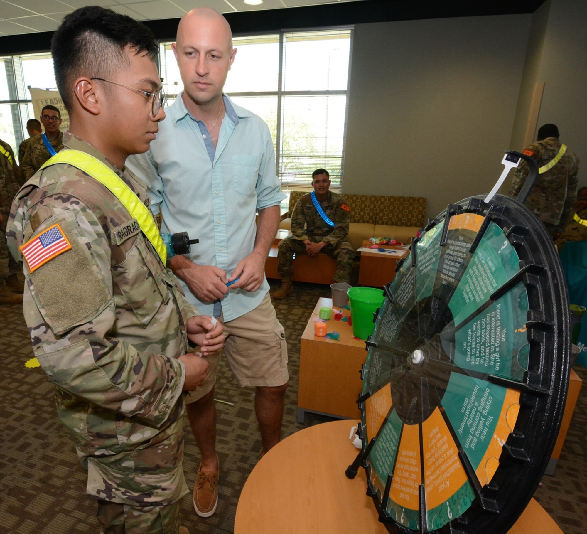 A Soldier spins the SHARP wheel that contains questions about the program.