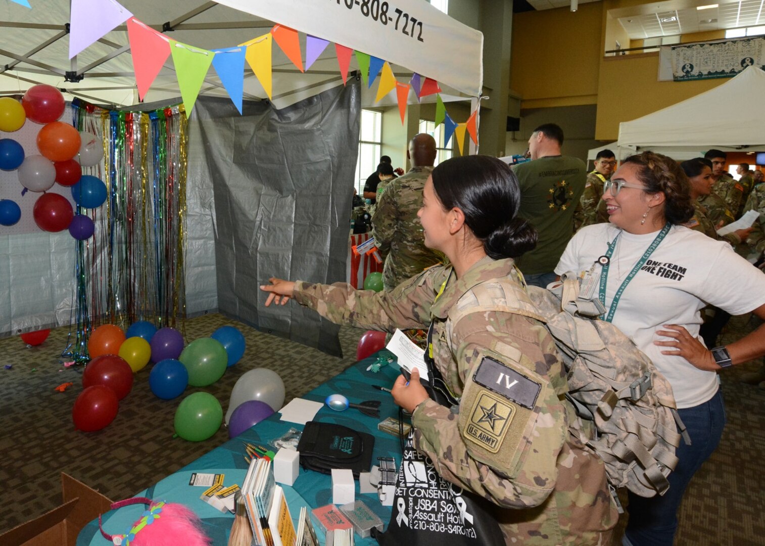 A Soldier throws a dart to receive a prize after correctly answering a question on the Army SHARP program.