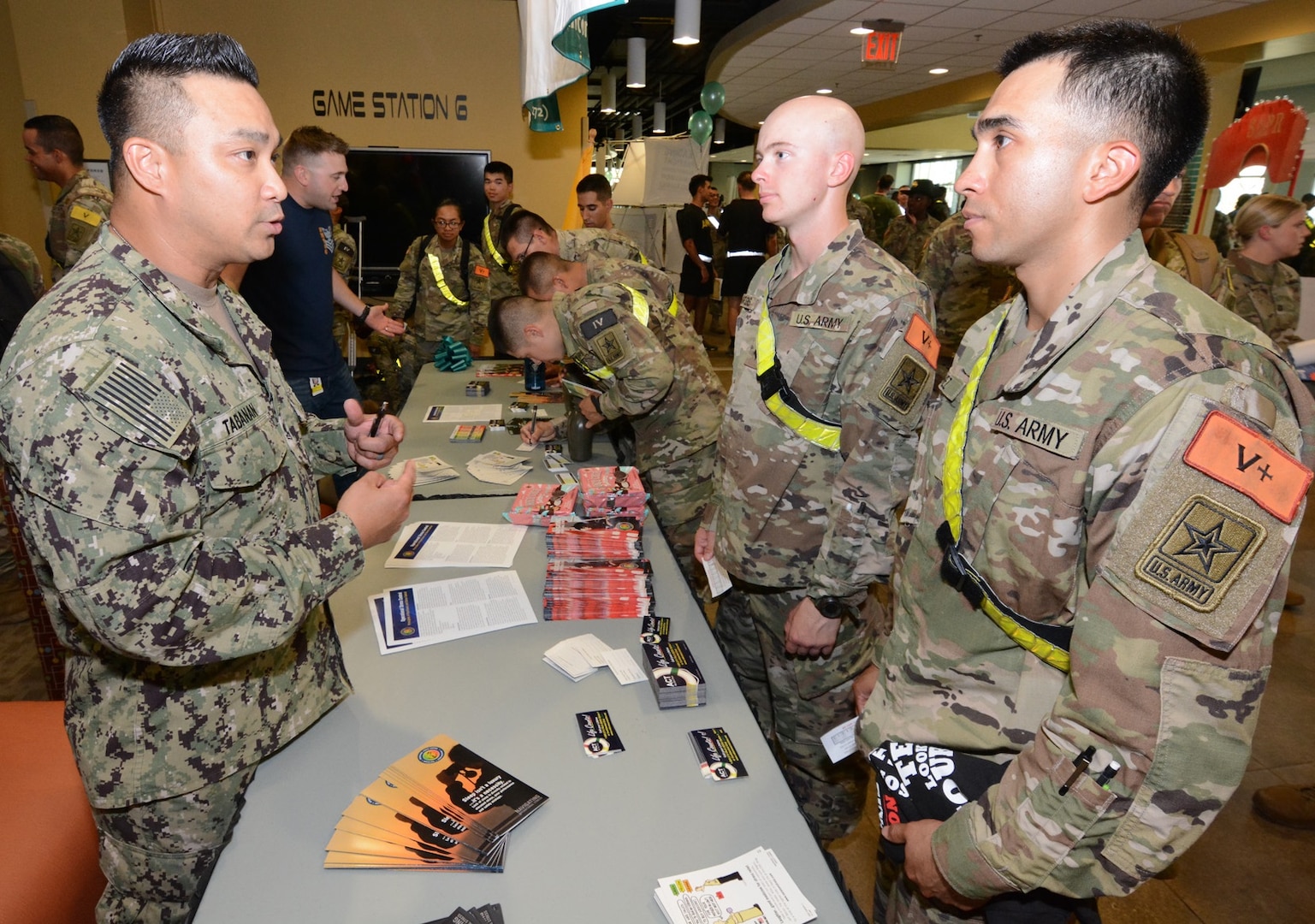 Soldiers stop by the Navy Ask, Care, and Treatment, or ACT, booth. The ACT program is a three-step process designed to help determine if someone is suicidal and to prevent them from hurting themselves.
