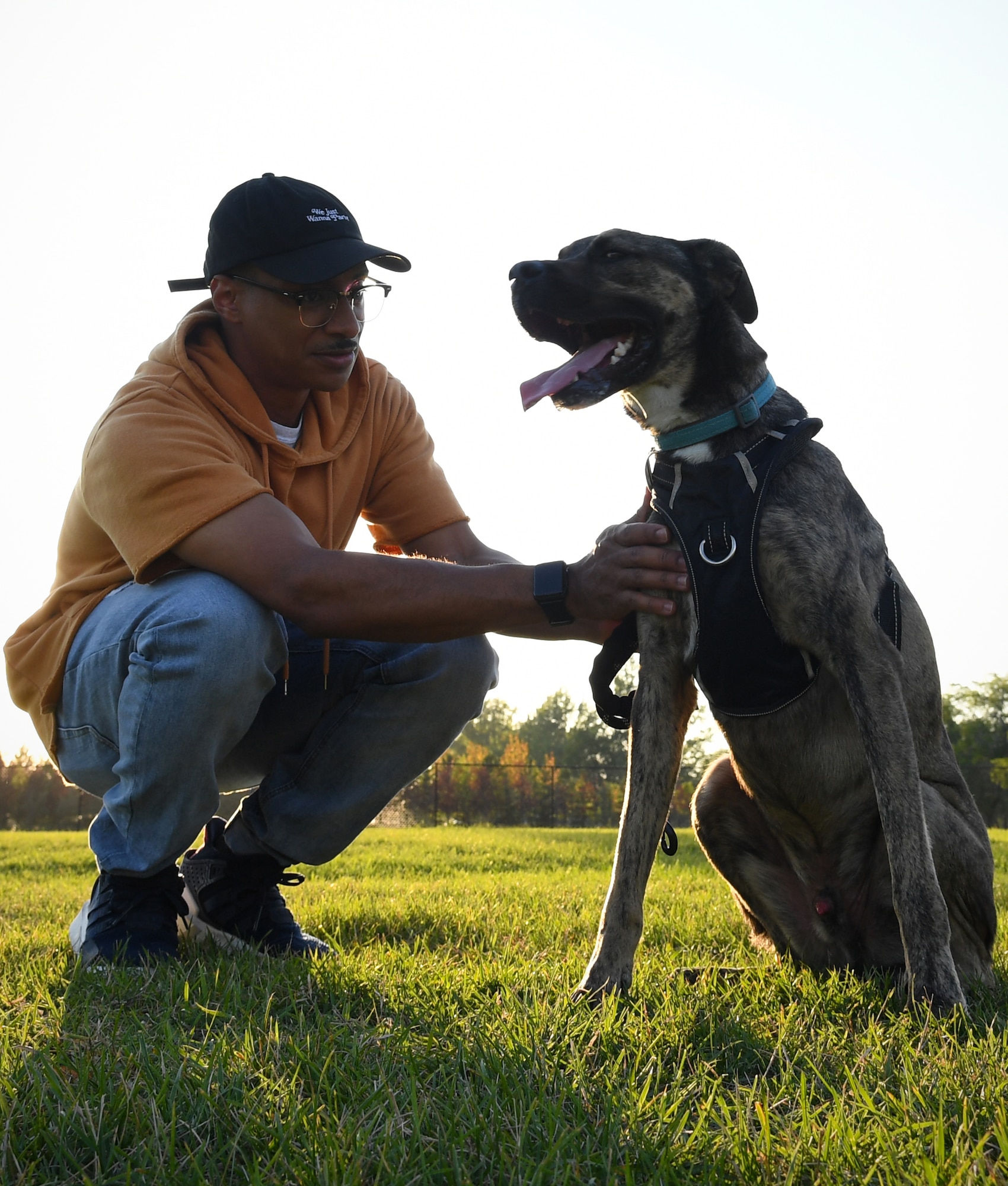 Senior Airman Elijaih Tiggs, 319th Reconnaissance Wing photojournalist journeyman, pets Memphis, his 2-year-old Australian Cattle Dog mix, as Memphis takes a play-break during “Tactical Paws” Sept. 18, 2019, at the dog park on Grand Forks Air Force Base, North Dakota. Tiggs and Memphis attended Tactical Paws, a casual event created to allow the base community to socialize, exercise their dogs and share helpful tips regarding local animal care options. (U.S. Air Force photo by Senior Airman Elora J. Martinez)