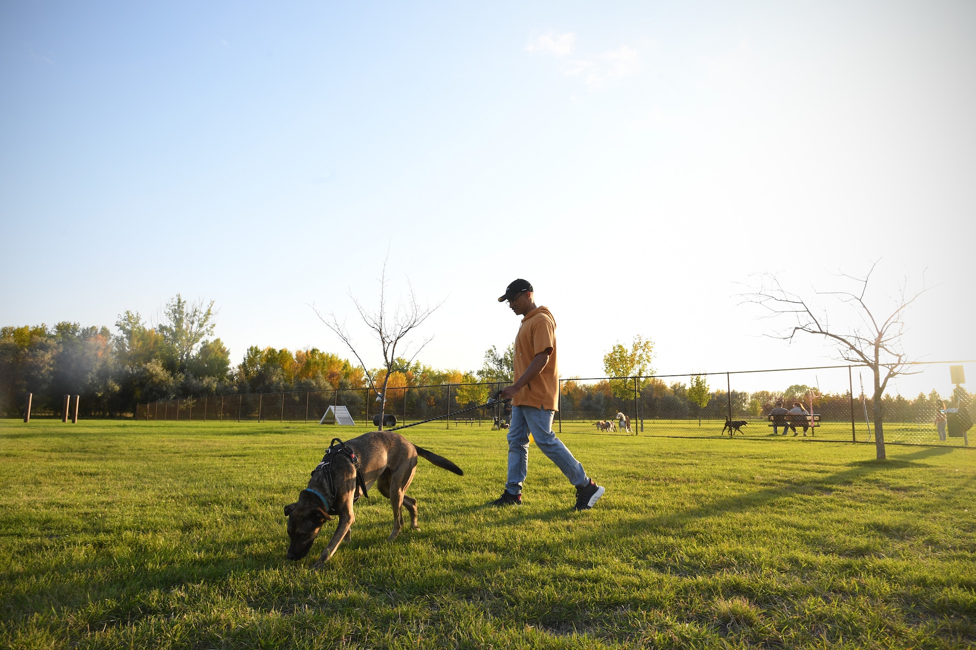 Senior Airman Elijaih Tiggs, 319th Reconnaissance Wing photojournalist journeyman, walks Memphis, his 2-year-old Australian Cattle Dog mix, out of the dog park after “Tactical Paws” Sept. 18, 2019, on Grand Forks Air Force Base, North Dakota. Tactical Paws was a base event for Airmen and their dogs to play, socialize and relax after work. The event was inspired by recent resilience tactical pauses across the U.S. Air Force, in which Airmen had a day to be with their wingmen and discuss the importance of mental health and different avenues of help or support offered to those who need it. (U.S. Air Force photo by Senior Airman Elora J. Martinez)