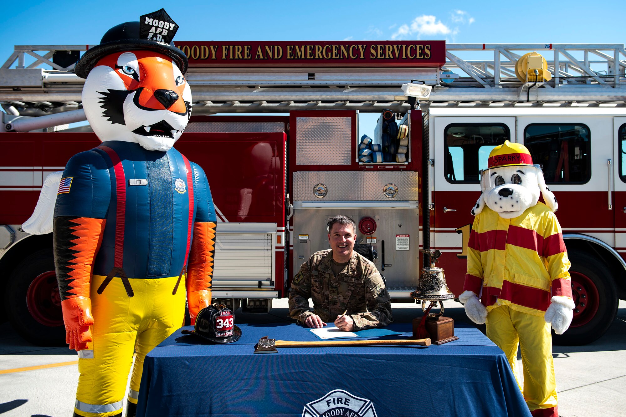 Col. Daniel P. Walls, 23d Wing commander, center, poses for a picture with 23d Civil Engineer Squadron mascots, Sparky and Firefighter Flying Tiger, Sept. 23, 2019, at Moody Air Force Base, Ga. Walls proclaimed the week of Oct. 6-12 as Fire Prevention Week, which is designed to commemorate the sacrifices of our firefighters and teach fire safety to others. (U.S. Air Force photo by Senior Airman Erick Requadt)