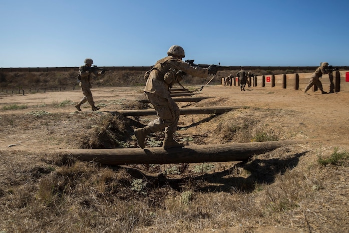Recruits with Kilo Company, 3rd Recruit Training Battalion, run over logs during field week at Marine Corps Base Camp Pendleton, California Sept. 13.