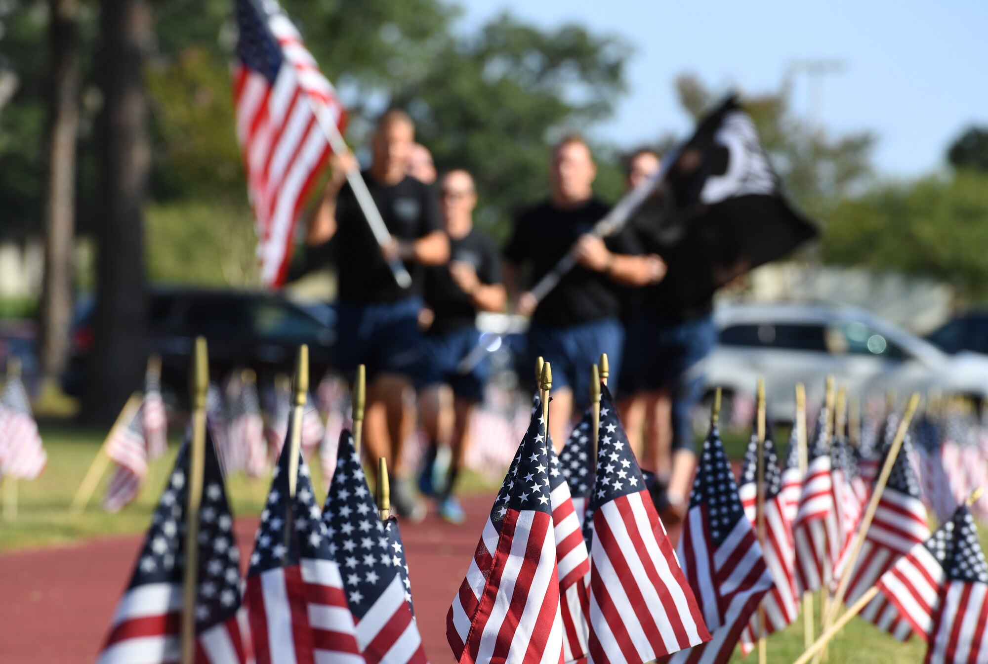 Flags line the track during Keesler’s POW/MIA 24-hour memorial run and vigil at the Crotwell Track on Keesler Air Force Base, Mississippi, Sept. 18, 2019. This event is held annually to raise awareness and pay tribute to all prisoners of war and the military members still missing in action. (U.S. Air Force photo by Kemberly Groue)