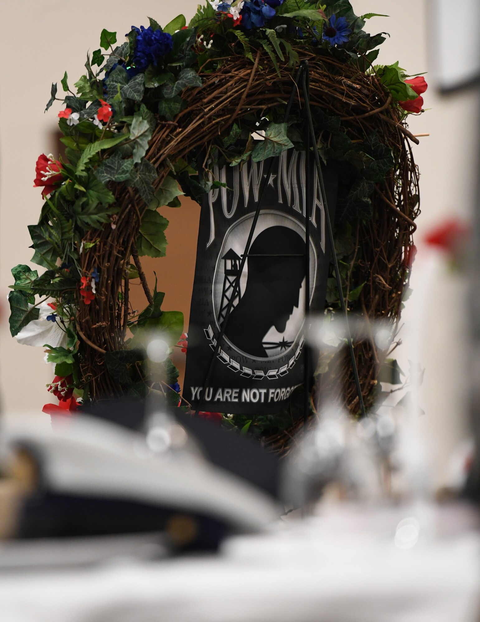 A wreath is on display during the POW/MIA remembrance luncheon inside the Roberts Consolidated Aircraft Maintenance Facility at Keesler Air Force Base, Mississippi, Sept. 20, 2019. The event, hosted by the Air Force Sergeants Association, was held to raise awareness and to pay tribute to all prisoners of war and those military members still missing in action. (U.S. Air Force photo by Kemberly Groue)