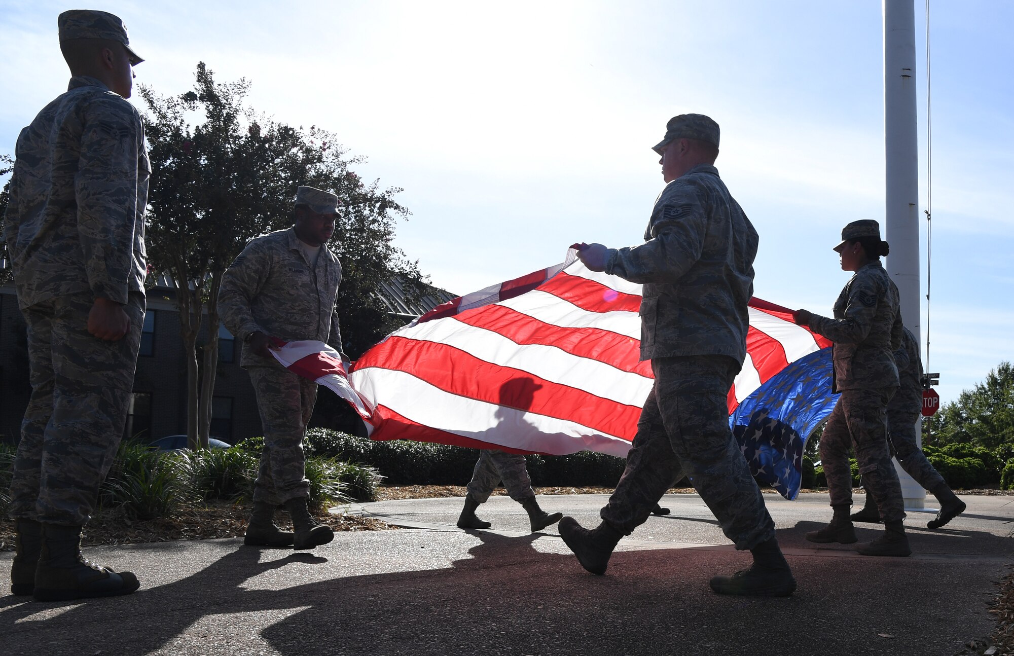 Keesler Airmen participate in folding the U.S. Flag during the POW/MIA retreat ceremony at Keesler Air Force Base, Mississippi, Sept. 20, 2019. The event was held to raise awareness and to pay tribute to all prisoners of war and those military members still missing in action. (U.S. Air Force photo by Kemberly Groue)