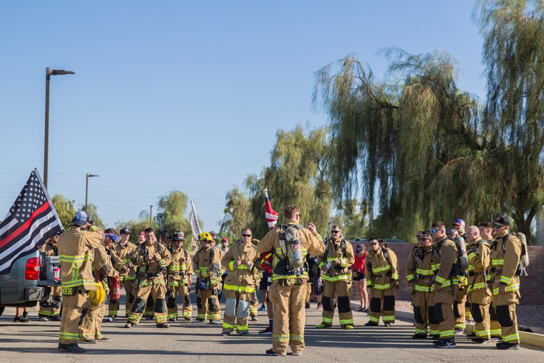 U.S. Marines with Aircraft Rescue and Firefighting (ARFF), Headquarters and Headquarters Squadron (H&HS), Marine Corps Air Station (MCAS) Yuma participate in Yuma's local 9/11 Moving Tribute 5K in Yuma, Ariz., Sept. 11, 2019. MCAS Yuma's ARFF ran alongside local fire departments, and civilians, remembering and honoring the victims of 9/11. The 5K began at City of Yuma Fire Station #3 and finished at City of Yuma Fire Station #1. (U.S. Marine Corps photo by Sgt. Allison Lotz)