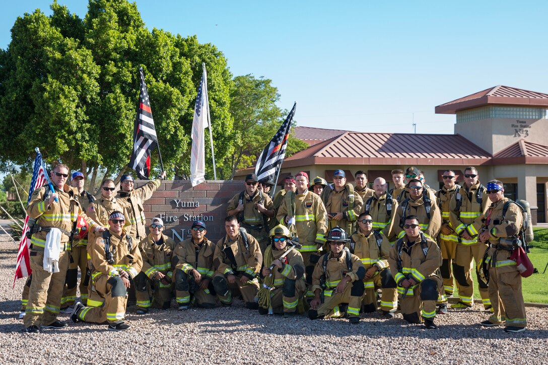 U.S. Marines with Aircraft Rescue and Firefighting (ARFF), Headquarters and Headquarters Squadron (H&HS), Marine Corps Air Station (MCAS) Yuma participate in Yuma's local 9/11 Moving Tribute 5K in Yuma, Ariz., Sept. 11, 2019. MCAS Yuma's ARFF ran alongside local fire departments, and civilians, remembering and honoring the victims of 9/11. The 5K began at City of Yuma Fire Station #3 and finished at City of Yuma Fire Station #1. (U.S. Marine Corps photo by Sgt. Allison Lotz)