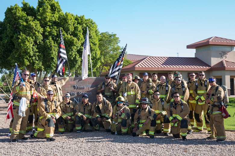 U.S. Marines with Aircraft Rescue and Firefighting (ARFF), Headquarters and Headquarters Squadron (H&HS), Marine Corps Air Station (MCAS) Yuma participate in Yuma's local 9/11 Moving Tribute 5K in Yuma, Ariz., Sept. 11, 2019. MCAS Yuma's ARFF ran alongside local fire departments, and civilians, remembering and honoring the victims of 9/11. The 5K began at City of Yuma Fire Station #3 and finished at City of Yuma Fire Station #1. (U.S. Marine Corps photo by Sgt. Allison Lotz)