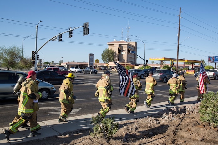 U.S. Marines with Aircraft Rescue and Firefighting (ARFF), Headquarters and Headquarters Squadron (H&HS), Marine Corps Air Station (MCAS) Yuma participate in Yuma's local 9/11 Moving Tribute 5K in Yuma, Ariz., Sept. 11, 2019. MCAS Yuma's ARFF ran alongside local fire departments, and civilians, remembering and honoring the victims of 9/11. The 5K began at City of Yuma Fire Station #3 and finished at City of Yuma Fire Station #1. (U.S. Marine Corps photo by Sgt. Allison Lotz)