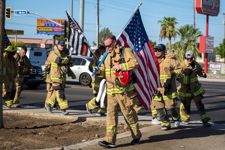 U.S. Marines with Aircraft Rescue and Firefighting (ARFF), Headquarters and Headquarters Squadron (H&HS), Marine Corps Air Station (MCAS) Yuma participate in Yuma's local 9/11 Moving Tribute 5K in Yuma, Ariz., Sept. 11, 2019. MCAS Yuma's ARFF ran alongside local fire departments, and civilians, remembering and honoring the victims of 9/11. The 5K began at City of Yuma Fire Station #3 and finished at City of Yuma Fire Station #1. (U.S. Marine Corps photo by Sgt. Allison Lotz)