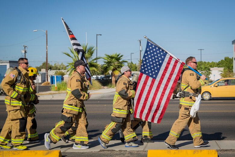 U.S. Marines with Aircraft Rescue and Firefighting (ARFF), Headquarters and Headquarters Squadron (H&HS), Marine Corps Air Station (MCAS) Yuma participate in Yuma's local 9/11 Moving Tribute 5K in Yuma, Ariz., Sept. 11, 2019. MCAS Yuma's ARFF ran alongside local fire departments, and civilians, remembering and honoring the victims of 9/11. The 5K began at City of Yuma Fire Station #3 and finished at City of Yuma Fire Station #1. (U.S. Marine Corps photo by Sgt. Allison Lotz)