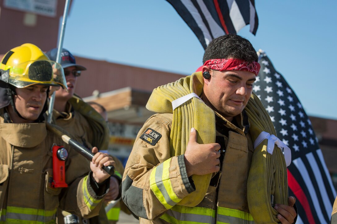 U.S. Marines with Aircraft Rescue and Firefighting (ARFF), Headquarters and Headquarters Squadron (H&HS), Marine Corps Air Station (MCAS) Yuma participate in Yuma's local 9/11 Moving Tribute 5K in Yuma, Ariz., Sept. 11, 2019. MCAS Yuma's ARFF ran alongside local fire departments, and civilians, remembering and honoring the victims of 9/11. The 5K began at City of Yuma Fire Station #3 and finished at City of Yuma Fire Station #1. (U.S. Marine Corps photo by Sgt. Allison Lotz)