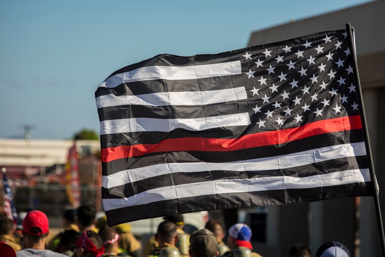 U.S. Marines with Aircraft Rescue and Firefighting (ARFF), Headquarters and Headquarters Squadron (H&HS), Marine Corps Air Station (MCAS) Yuma participate in Yuma's local 9/11 Moving Tribute 5K in Yuma, Ariz., Sept. 11, 2019. MCAS Yuma's ARFF ran alongside local fire departments, and civilians, remembering and honoring the victims of 9/11. The 5K began at City of Yuma Fire Station #3 and finished at City of Yuma Fire Station #1. (U.S. Marine Corps photo by Sgt. Allison Lotz)