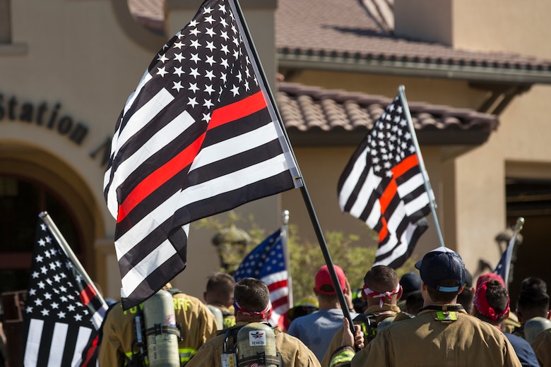 U.S. Marines with Aircraft Rescue and Firefighting (ARFF), Headquarters and Headquarters Squadron (H&HS), Marine Corps Air Station (MCAS) Yuma participate in Yuma's local 9/11 Moving Tribute 5K in Yuma, Ariz., Sept. 11, 2019. MCAS Yuma's ARFF ran alongside local fire departments, and civilians, remembering and honoring the victims of 9/11. The 5K began at City of Yuma Fire Station #3 and finished at City of Yuma Fire Station #1. (U.S. Marine Corps photo by Sgt. Allison Lotz)
