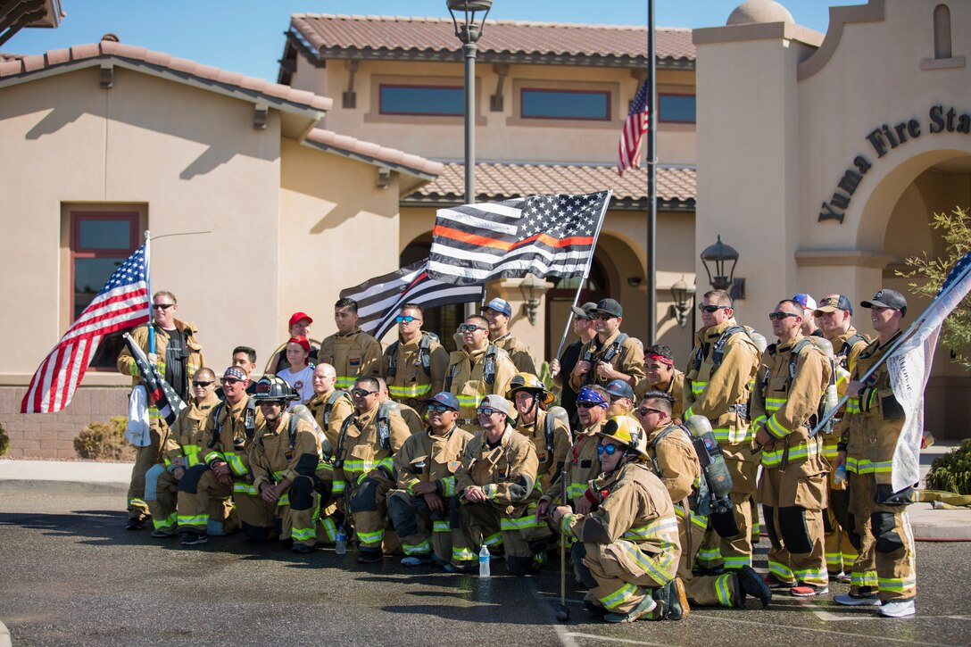 U.S. Marines with Aircraft Rescue and Firefighting (ARFF), Headquarters and Headquarters Squadron (H&HS), Marine Corps Air Station (MCAS) Yuma participate in Yuma's local 9/11 Moving Tribute 5K in Yuma, Ariz., Sept. 11, 2019. MCAS Yuma's ARFF ran alongside local fire departments, and civilians, remembering and honoring the victims of 9/11. The 5K began at City of Yuma Fire Station #3 and finished at City of Yuma Fire Station #1. (U.S. Marine Corps photo by Sgt. Allison Lotz)