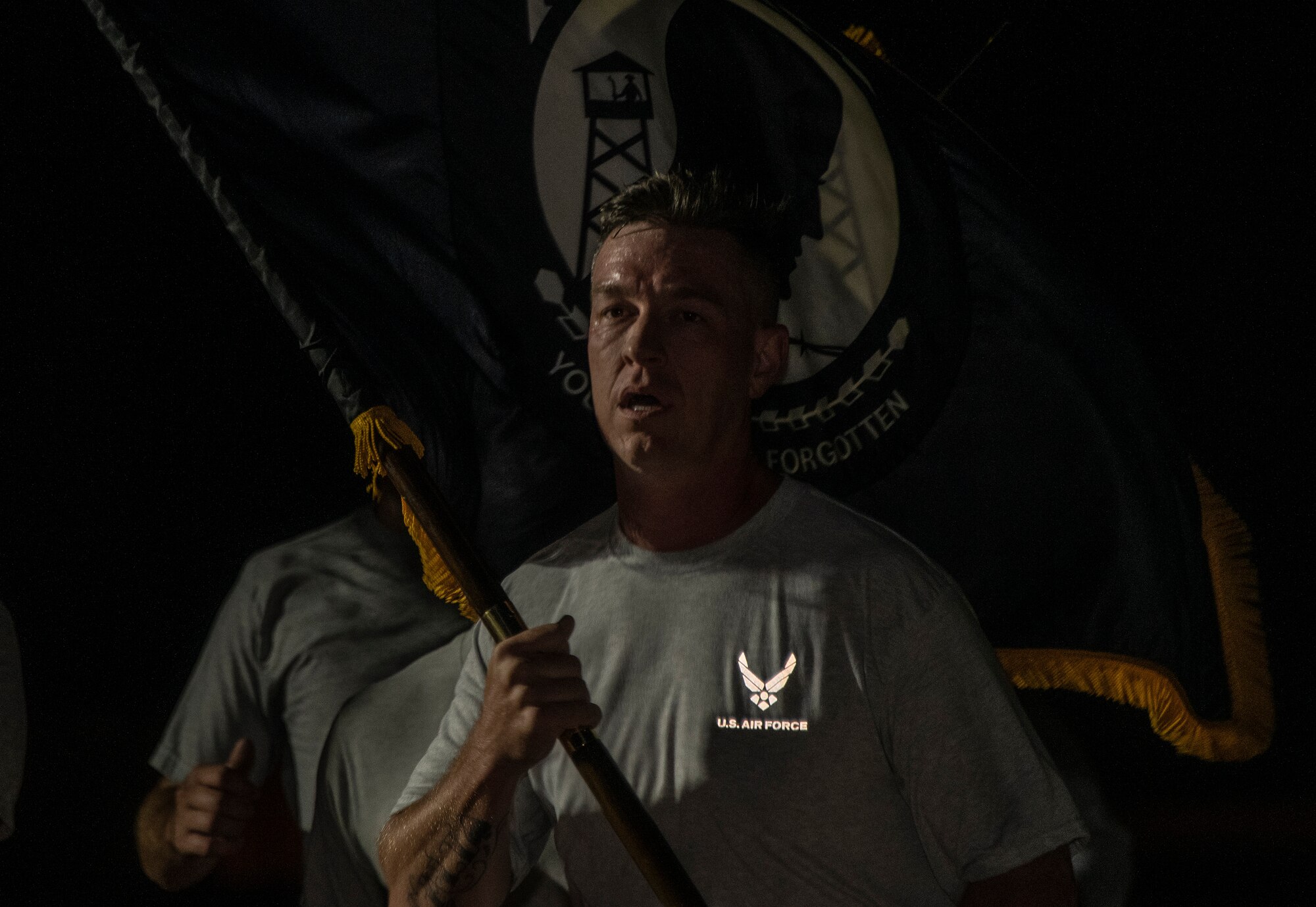 U.S. Air Force Senior Master Sgt. Mark Welling, 860th Aircraft Maintenance Squadron assistant aircraft maintenance unit superintendent, carries the POW/MIA flag, Sept. 20, 2019, at Travis Air Force Base, California. Service members, civilians and family members kept the U.S. and POW/MIA flags in constant motion for a 24-hour period. According to the Defense POW/MIA Accounting Agency, more than 82,000 Americans remain missing from WWII, Korean War, Vietnam War, Cold War, Gulf Wars and other conflicts. The names of service members still unaccounted for were recited throughout the run. (U.S. Air Force photo by Heide Couch)