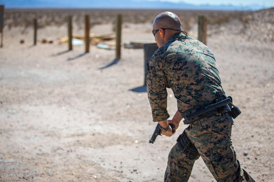 U.S. Marines with the Provost Marshals Office (PMO), Headquarters and Headquarters Squadron, Marine Corps Air Station (MCAS) Yuma, engage targets during a law enforcement (LE) range qualification on MCAS Yuma, Sep. 18th 2019. The LE qualification is specific to military police personnel, including several different shooting methods with both the Beretta M9 and Benelli 12 gauge shotgun. (U.S. Marine Corps photo by Lance Cpl John Hall)