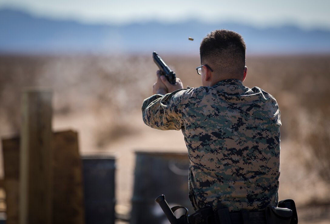 U.S. Marines with the Provost Marshals Office (PMO), Headquarters and Headquarters Squadron, Marine Corps Air Station (MCAS) Yuma, engage targets during a law enforcement (LE) range qualification on MCAS Yuma, Sep. 18th 2019. The LE qualification is specific to military police personnel, including several different shooting methods with both the Beretta M9 and Benelli 12 gauge shotgun. (U.S. Marine Corps photo by Lance Cpl John Hall)