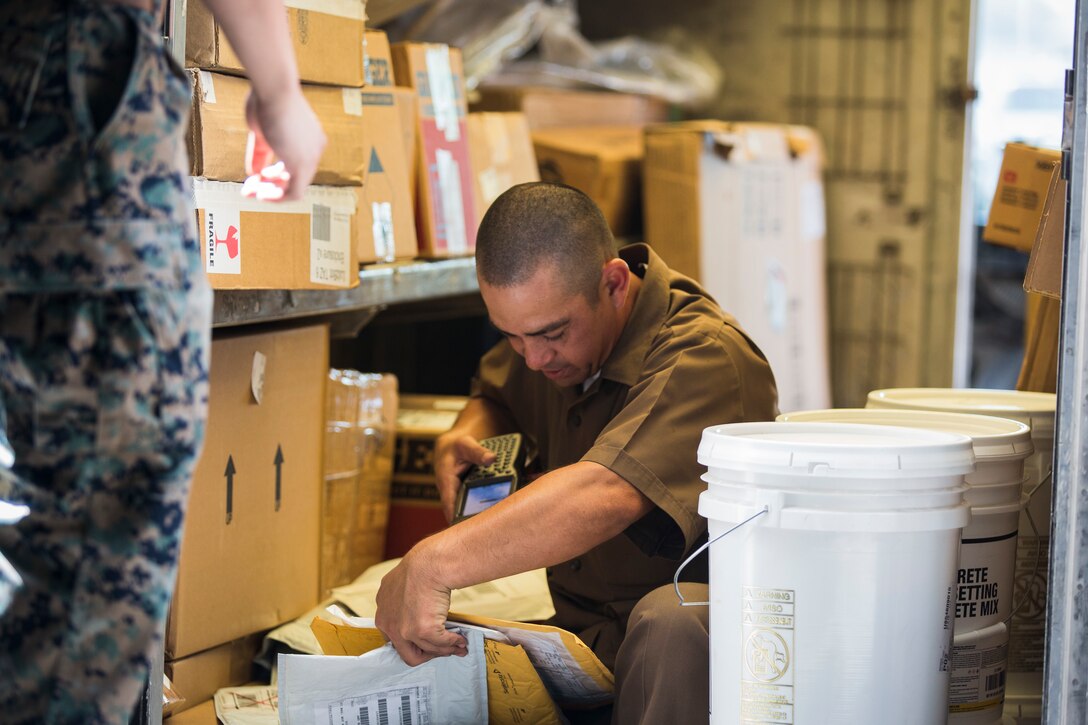 U.S. Marine Corps Cpl. Justus Abarquez, a distribution management Marine assigned to Headquarters and Headquarters Squadron (H&HS), helps Marines assigned to Marine Aviation Logistic Squadron 13 (MALS-13) take inventory of their newly signed-for gear on Marine Corps Air Station (MCAS) Yuma, Ariz., Sept. 9, 2019. As a distribution management Marine, Cpl. Abarquez plays an important part in allowing the Distribution Management Office (DMO) to support all of the units aboard MCAS Yuma by recieving, shipping, and distributing all packages to their respective units on the air station. (U.S. Marine Corps photo by Sgt. Isaac D. Martinez)