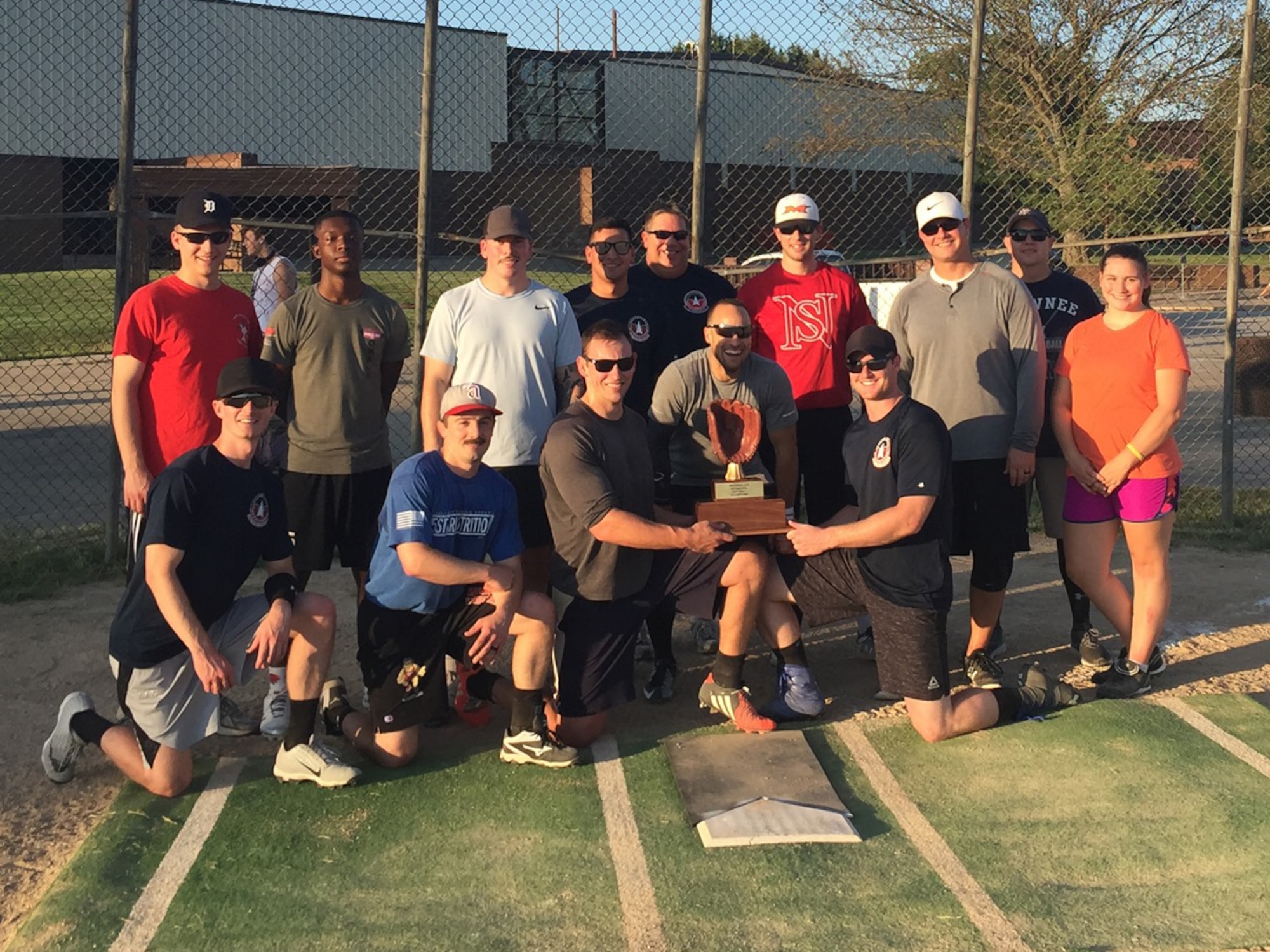 The 20th Attack Squadron softball team poses for a photo at Whiteman Air Force Base, Missouri, Aug. 13, 2019 after cementing their historical season with a victory. The Hellhounds went 18-0, being the first ever undefeated team on base.  (U.S. Air Force courtesy photo)