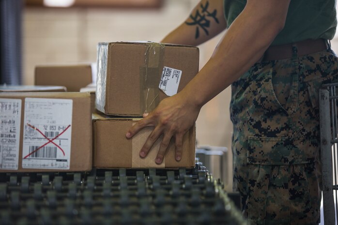 U.S. Marine Corps Cpl. Justus Abarquez, a distribution management Marine assigned to Headquarters and Headquarters Squadron (H&HS), helps Marines assigned to Marine Aviation Logistic Squadron 13 (MALS-13) take inventory of their newly signed-for gear on Marine Corps Air Station (MCAS) Yuma, Ariz., Sept. 9, 2019. As a distribution management Marine, Cpl. Abarquez plays an important part in allowing the Distribution Management Office (DMO) to support all of the units aboard MCAS Yuma by recieving, shipping, and distributing all packages to their respective units on the air station. (U.S. Marine Corps photo by Sgt. Isaac D. Martinez)