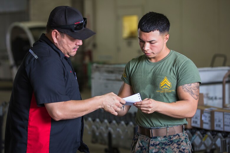 U.S. Marine Corps Cpl. Justus Abarquez, a distribution management Marine assigned to Headquarters and Headquarters Squadron (H&HS), helps Marines assigned to Marine Aviation Logistic Squadron 13 (MALS-13) take inventory of their newly signed-for gear on Marine Corps Air Station (MCAS) Yuma, Ariz., Sept. 9, 2019. As a distribution management Marine, Cpl. Abarquez plays an important part in allowing the Distribution Management Office (DMO) to support all of the units aboard MCAS Yuma by recieving, shipping, and distributing all packages to their respective units on the air station. (U.S. Marine Corps photo by Sgt. Isaac D. Martinez)