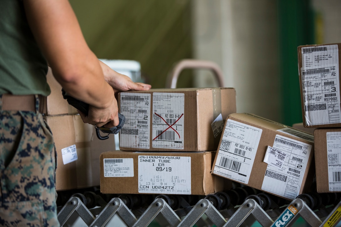 U.S. Marine Corps Cpl. Justus Abarquez, a distribution management Marine assigned to Headquarters and Headquarters Squadron (H&HS), helps Marines assigned to Marine Aviation Logistic Squadron 13 (MALS-13) take inventory of their newly signed-for gear on Marine Corps Air Station (MCAS) Yuma, Ariz., Sept. 9, 2019. As a distribution management Marine, Cpl. Abarquez plays an important part in allowing the Distribution Management Office (DMO) to support all of the units aboard MCAS Yuma by recieving, shipping, and distributing all packages to their respective units on the air station. (U.S. Marine Corps photo by Sgt. Isaac D. Martinez)