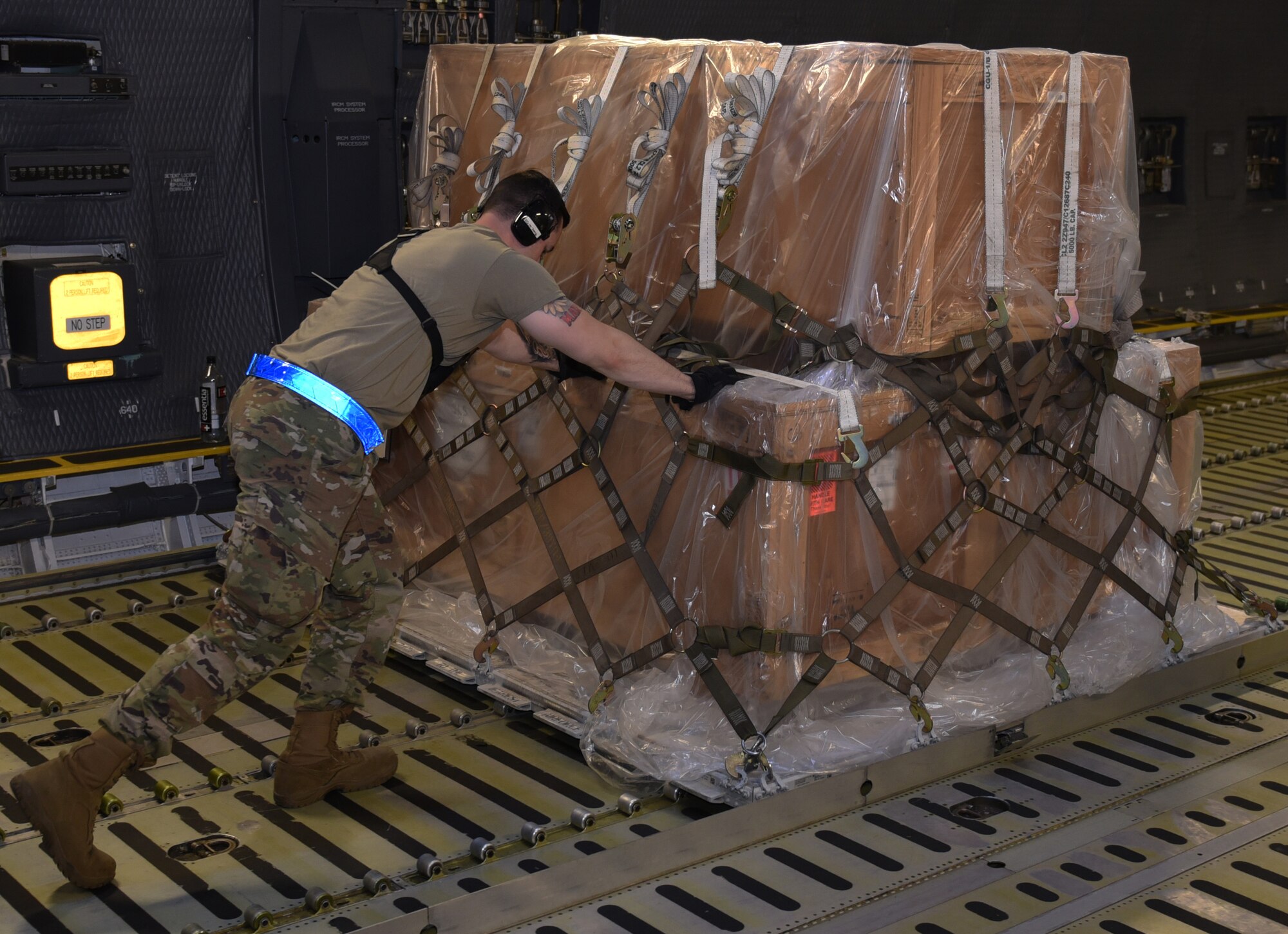 U.S. Air Force Staff Sgt. Ryan Botts, 60th Aerial Port Squadron ramp services supervisor, pushes cargo onto a C-5M Super Galaxy Sept. 13, 2019, at Travis Air Force Base, California. Mobility Guardian 2019 is Air Mobility Command’s largest enterprise-wide training event with more than 4,000 joint and international personnel integrated to hone teamwork and improve longstanding partnerships. MG19 also validates the Air Force’s readiness to conduct mobility operations in contested, degraded and operationally-limited environments. (U.S. Air Force photo by Airman 1st Class Cameron Otte)