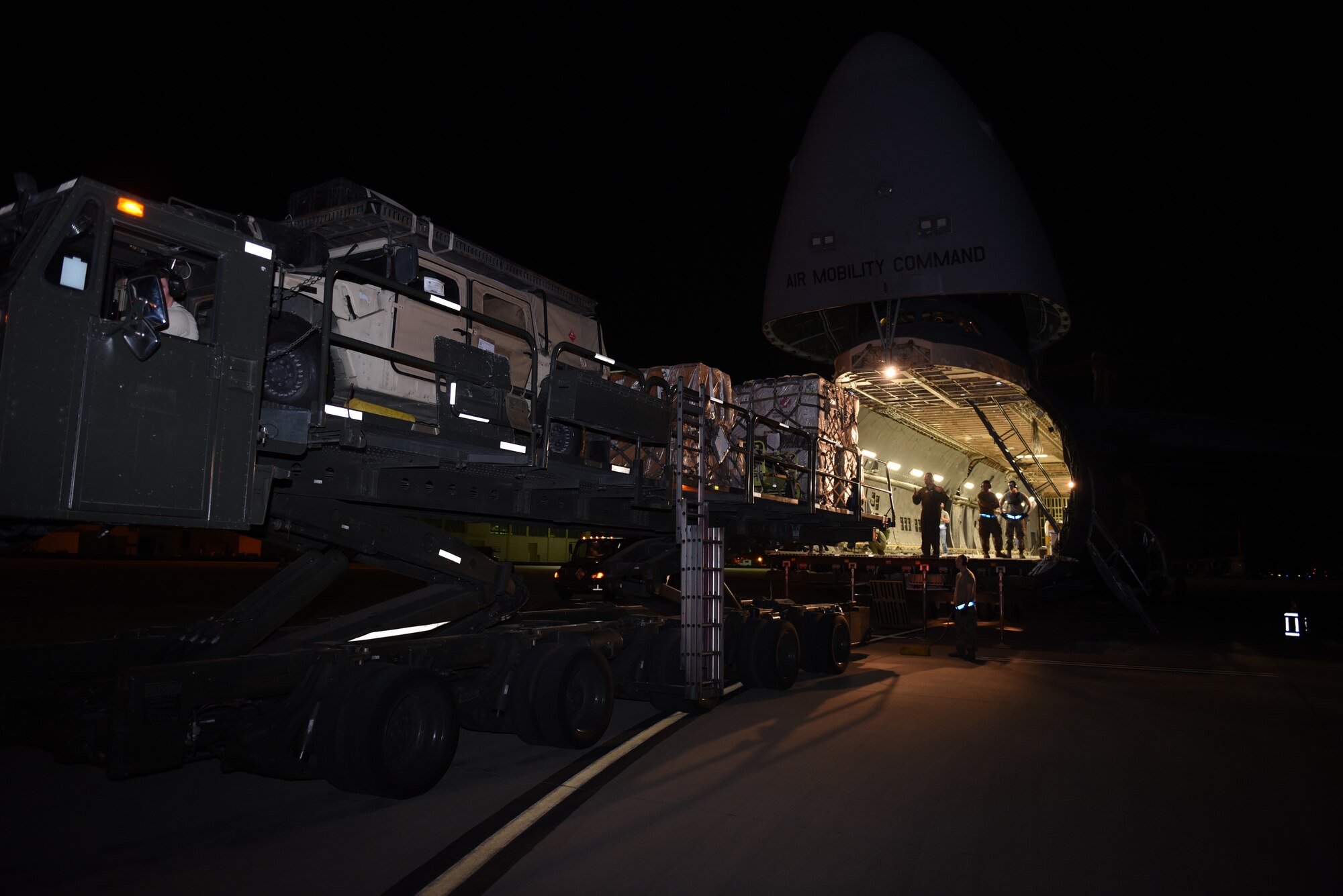 U.S. Airmen from the 60th Aerial Port Squadron and 9th Airlift Squadron line up a cargo transporter to load cargo inside a C-5M Super Galaxy Sept. 13, 2019, at Travis Air Force Base, California. Mobility Guardian 2019 is Air Mobility Command’s largest enterprise-wide training event with more than 4,000 joint and international personnel integrated to hone teamwork and improve longstanding partnerships. MG19 also validates the Air Force’s readiness to conduct mobility operations in contested, degraded and operationally-limited environments. (U.S. Air Force photo by Airman 1st Class Cameron Otte)