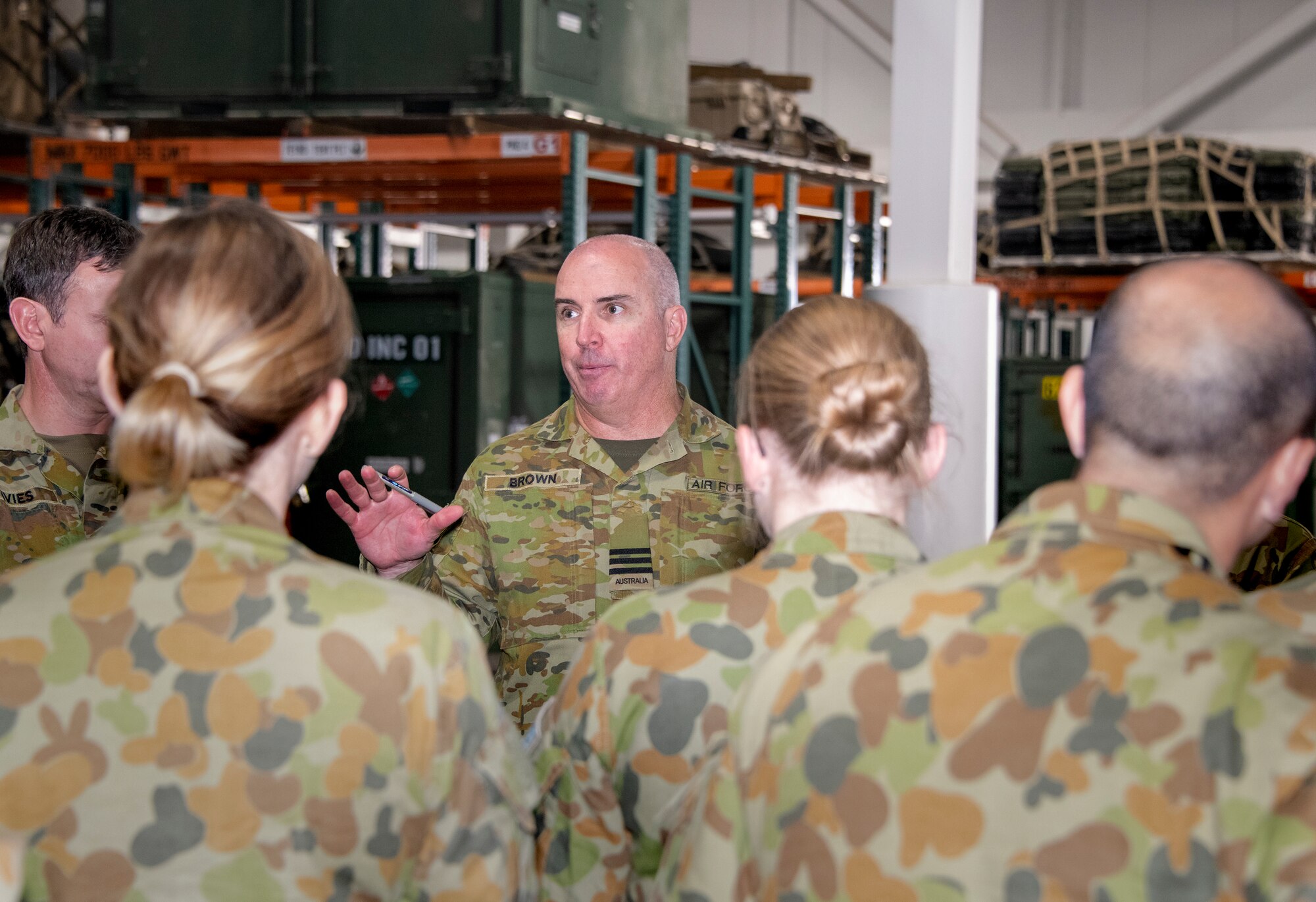 Royal Australian Air Force Wing Commander Alan Brown, No. 383 Contingency Response Squadron, talks with members of the RAAF Task Element 640.10.5 after a Mobility Guardian mission brief Sept. 11, 2019, at Travis Air Force Base, California. Mobility Guardian is Air Mobility Command’s full spectrum readiness exercise, which is designed to strengthen and improve integrated teamwork. U.S. aircraft will join aircraft from more than two dozen nations along with more than 4,000 U.S. and international Air Force, Army, Navy, and Marine Corps service members. (U.S. Air Force photo by Heide Couch)