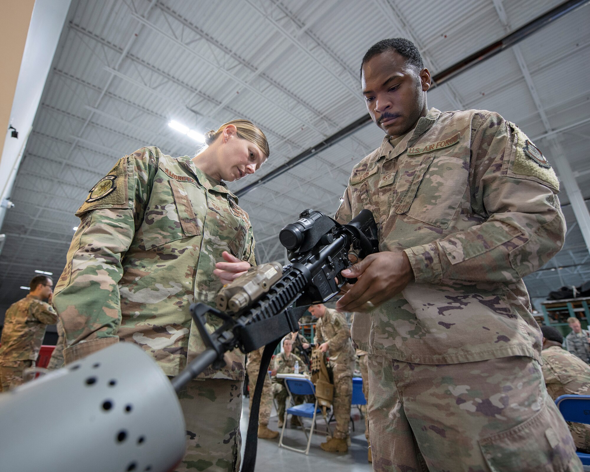 U.S. Air Force Tech. Sgt. Cicily Amonett, left, 321st Contingency Response Squadron assistant flight chief, assists as Staff Sgt. Jarrod Perry, 321st CRS crew chief, clears his weapon during deployment processing Sept. 14, 2019, at Travis Air Force Base, California. Contingency response forces from the U.S. and Royal Australian Air Forces staged at Travis AFB before deploying in support of exercise Mobility Guardian 2019. MG19 is Air Mobility Command’s flagship exercise for large-scale rapid global mobility operations. Forty-six U.S. aircraft will join aircraft from 29 international partners, along with more than 4,000 U.S. and international Air Force, Army, Navy and Marine Corps aviators. (U.S. Air Force photo by Louis Briscese)